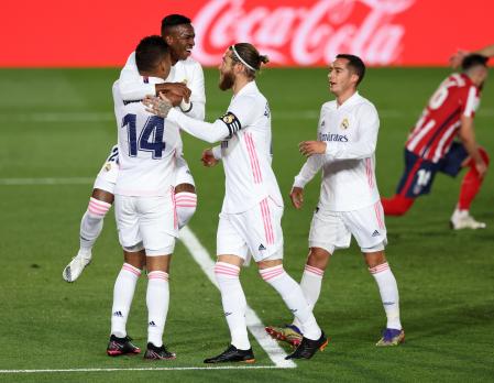 MADRID, SPAIN - DECEMBER 12: Casemiro of Real Madrid (L) celebrates with teammates Sergio Ramos, Vinicius Junior and Lucas Vazquez (R) after scoring their sides first goal during the La Liga Santander match between Real Madrid and Atletico de Madrid at Estadio Alfedo Di Stefano on December 12, 2020 in Madrid, Spain. Sporting stadiums around Spain remain under strict restrictions due to the Coronavirus Pandemic as Government social distancing laws prohibit fans inside venues resulting in games being played behind closed doors. (Photo by Angel Martinez/Getty Images)