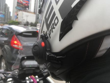 Detalle de un intercomunicador acoplado al casco de un motorista