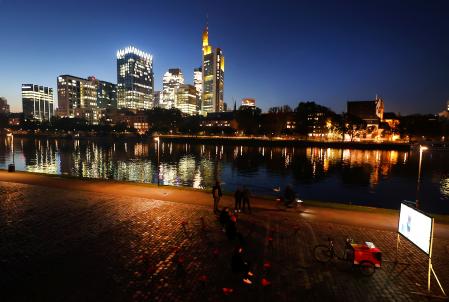 People watch a movie at the bank of river Main in Frankfurt, Germany, October 19, 2021.  REUTERS/Kai Pfaffenbach