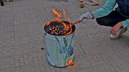 Torrando castañas en la calle.
