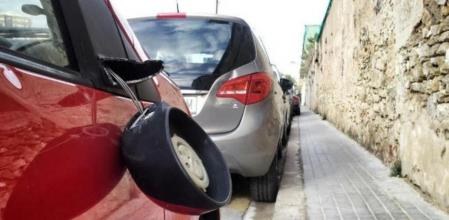 Un coche aparcado con el retrovisor del acompañante roto&nbsp;