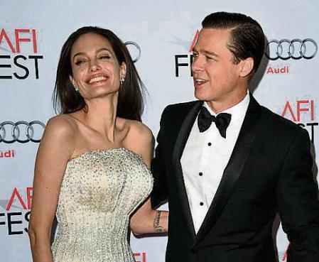 (FILES) In this file photo taken on November 05, 2015, actors Angelina Jolie Pitt and Brad Pitt arrive for the opening night gala premiere of Universal Pictures' 'By the Sea' during AFI FEST 2015 presented by Audi at the TCL Chinese Theatre in Hollywood. - Pitt is suing Jolie for selling her share of the French vineyard where they got married. The actors, who were once Hollywood's highest profile couple, bought a controlling stake of Chateau Miraval in southern France in 2008, and tied the knot there six years later. But they filed to dissolve their marriage in 2016 and have remained locked in court battles since, including over custody rights for their six children. (Photo by MARK RALSTON / AFP)
