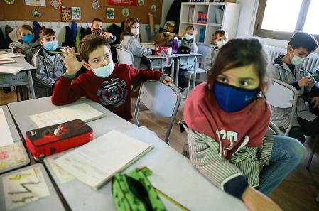 foto XAVIER CERVERA 10/01/2022 el profesor de primaria Alex Paris (y docente en practicas Arnau) imparte la clase de 'Medi' (ciencias naturales ,sociales, medioambientales,...) en una aula clase de tercero de primaria (9 años) en la 'vuelta al cole' tras las vacaciones navideñas marcadas por la sexta ola en la pandemia covid; de todos los alumnos solo ha fallado uno (y de profesores, solo tres de 200) escola escuela Pia (escolapios) de Sarria ,Barcelona todos los estudiantes con mascarilla, y el tutor tambien claro (permisos menores gestionado por una de las madres, Marta Ferrer, responsable d comunicación del centro)