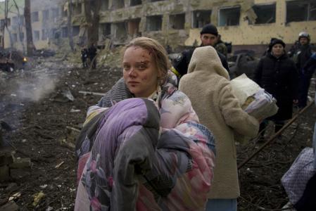 FILE - Mariana Vishegirskaya stands outside a maternity hospital that was damaged by shelling in Mariupol, Ukraine, March 9, 2022. Vishegirskaya survived the shelling and later gave birth to a girl in another hospital in Mariupol. (AP Photo/Mstyslav Chernov, File)