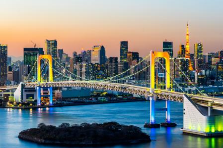 Una imagen nocturna del puente Rainbow iluminado en Tokio