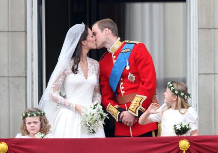 Britain's Prince William kisses his wife Kate Middleton, Duchess of Cambridge on the balcony of Buckingham Palace after the Royal Wedding in London Friday, April, 29, 2011.