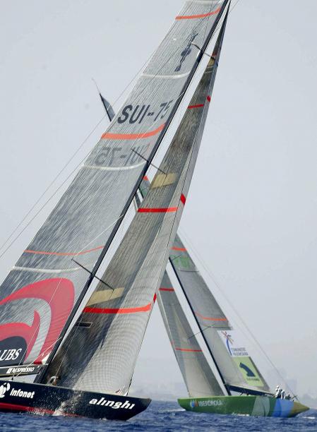 Swiss Team Alinghi (L) manoeuvers next to Spanish team Iberdrola (R), 19 June 2005, during the fourth leg of the match racing pre-regata for the Lois Vuiton Cup Act 4 ahead of the 32nd America Cup set in Valencia, Eastern Spain in 2007. 
                     AFP PHOTO /JOSE JORDAN (Photo by JOSE JORDAN / AFP)