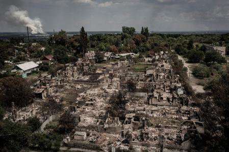 TOPSHOT - An aerial view shows destroyed houses after strike in the town of Pryvillya at the eastern Ukrainian region of Donbas on June 14, 2022, amid Russian invasion of Ukraine. - The cities of Severodonetsk and Lysychansk, which are separated by a river, have been targeted for weeks as the last areas still under Ukrainian control in the eastern Lugansk region. (Photo by ARIS MESSINIS / AFP)