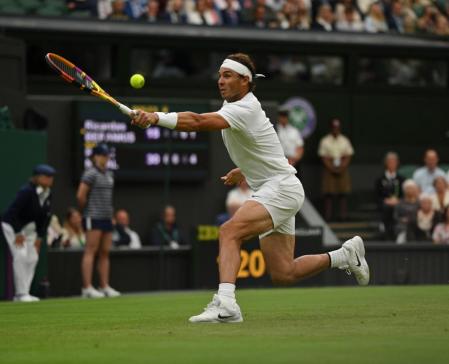 LONDON, ENGLAND - JUNE 30: Rafael Nadal of Spain plays a backhand against Ricardas Berankis of Lithuania during their Men's Singles Second Round match on day four of The Championships Wimbledon 2022 at All England Lawn Tennis and Croquet Club on June 30, 2022 in London, England. (Photo by Justin Setterfield/Getty Images)