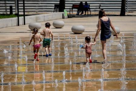 FOTO ALEX GARCIA OLA DE CALOR. VECINOS DE SANT ANDREU SE REFRESCAN EN UNA FUENTE PUBLICA 2022/07/17