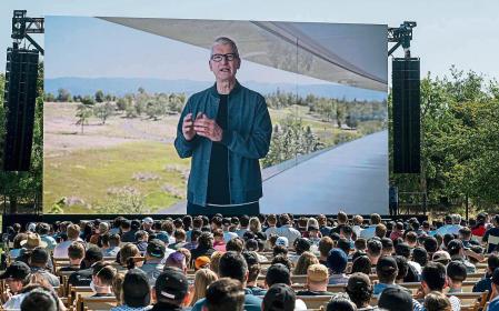 Tim Cook, chief executive officer of Apple Inc., displayed on a projection screen while speaking during the Apple Worldwide Developers Conference at Apple Park campus in Cupertino, California, US, on Monday, June 6, 2022. Apple unveiled a flurry of new software features and services including an updated iPhone lock screen and a pay-later option that pushes the tech giant deeper into finance. Photographer: David Paul Morris/Bloomberg via Getty Images