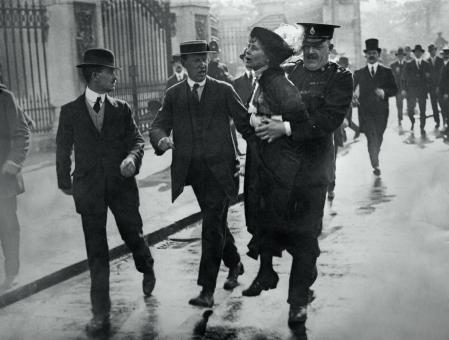 Outside Buckingham Palace, English suffragette Emmeline Pankhurst (1858 - 1928), is arrested and carried away by Superintendent Rolfe at a march, organised by Pankhurst, to petition King George V, London, 21st May 1914. On arrival at the palace, the marchers were met with force by the police and violence from the crowd of onlookers.  (Photo by Jimmy Sime/Central Press/Hulton Archive/Getty Images)