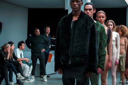 FILE PHOTO: Singer Kanye West (4th L) watches models before presenting his Fall/Winter 2015 partnership with Adidas at New York Fashion Week February 12, 2015. REUTERS/Lucas Jackson/File Photo