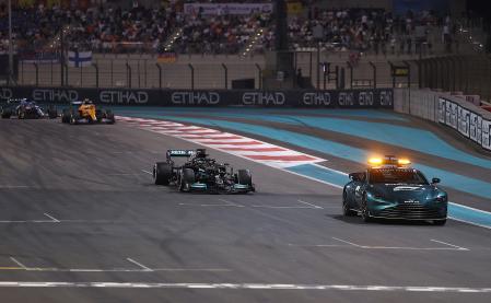 ABU DHABI, UNITED ARAB EMIRATES - DECEMBER 12: The FIA Safety Car leads Lewis Hamilton of Great Britain driving the (44) Mercedes AMG Petronas F1 Team Mercedes W12 and the rest of the field during the F1 Grand Prix of Abu Dhabi at Yas Marina Circuit on December 12, 2021 in Abu Dhabi, United Arab Emirates. (Photo by Lars Baron/Getty Images)
