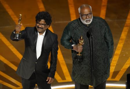 M.M. Keeravaani, right, and Chandrabose accept the award for best original song for 