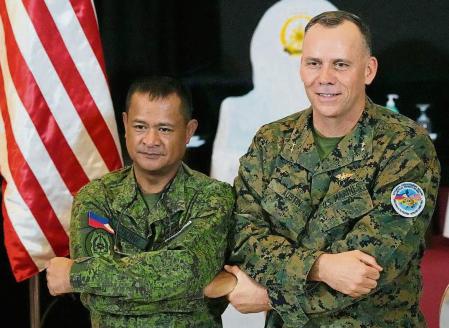 U.S. Marine Corps Major General Eric Austin, right, U.S. exercise director representative, and Philippine Army Major General Marvin Licudin, Philippine exercise director pose after the opening ceremonies of a joint military exercise flag called 