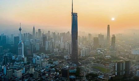 The sun rises over downtown Kuala Lumpur, Malaysia on April 11, 2023. (AP Photo/Vincent Thian)