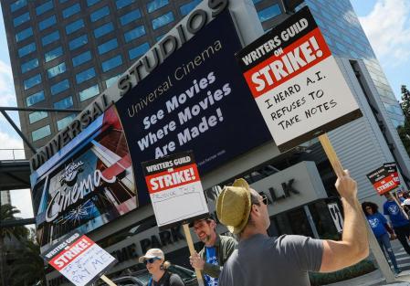 LOS ANGELES, CA - MAY 3: Members of the Writers Guild of America (WGA) and its supporters picket outside of Universal Studios on May 3, 2023 in Universal City, California. Writers Guild of America members have gone on strike in a contract dispute with studios and streaming services over lowering wages, residuals and the future of AI in entertainment. Rodin Eckenroth/Getty Images/AFP (Photo by Rodin Eckenroth / GETTY IMAGES NORTH AMERICA / Getty Images via AFP)