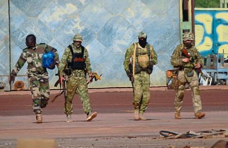 FILE - This undated file photograph issued by French military shows three Russian mercenaries, right, in northern Mali. Russia has engaged in under-the-radar military operations in at least half a dozen countries in Africa in the last five years using a shadowy mercenary force analysts say is loyal to President Vladimir Putin. Russia’s invasion of Ukraine is certain to dominate an upcoming NATO summit in Madrid. But host nation Spain and other members are quietly pushing the Western alliance to consider how mercenaries aligned with Russian President Vladimir Putin are spreading Moscow’s influence in Africa. (French Army via AP, File)