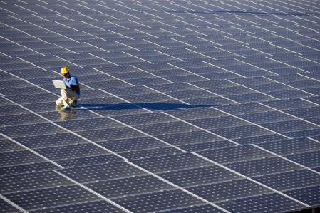 Image of a Engineer with a laptop at a photovoltaic farm (ISO 100). All my images have been processed in 16 Bits and transfer down to 8 before uploading.