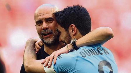 Soccer Football - FA Cup Final - Manchester City v Manchester United - Wembley Stadium, London, Britain - June 3, 2023 Manchester City manager Pep Guardiola and Ilkay Gundogan celebrate after winning the FA Cup REUTERS/Carl Recine
