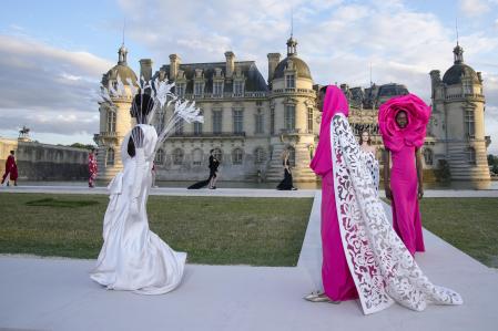 Models wear creations for the Valentino Haute Couture Fall/winter 2023-2024 fashion collection presented in Chantilly, north of Paris, Wednesday, July 5, 2023. (AP Photo/Christophe Ena)