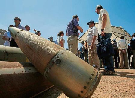 FILE - Activists and international delegations stand next to cluster bomb units, during a visit to a Lebanese military base at the opening of the Second Meeting of States Parties to the Convention on Cluster Munitions, in the southern town of Nabatiyeh, Lebanon, Sept. 12, 2011. The Biden administration has decided to provide cluster munitions to Ukraine and is expected to announce on Friday, July 6, 2023, that the Pentagon will send thousands as part of the latest military aid package for the war effort against Russia, according to people familiar with the decision. (AP Photo/Mohammed Zaatari, File)