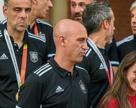 President of Spain's soccer federation, Luis Rubiales, center, stands with Spain's Women's World Cup soccer team after their World Cup victory at La Moncloa Palace in Madrid, Spain, Tuesday, Aug. 22, 2023. Moments after Spain won the Women's World Cup, the man who leads the country's national soccer federation took some unwanted attention away from the celebrating players. Criticism from the Spanish government and the soccer world rained down Monday on Luis Rubiales for his inappropriate conduct while reveling in Spain's 1-0 win over England in Sunday's final in Sydney, Australia. (AP Photo/Manu Fernandez)