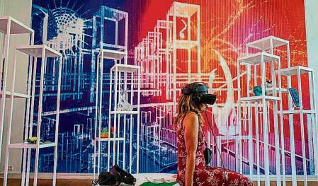 A visitor uses VR glasses to experience German artist Marlene Bart's work 