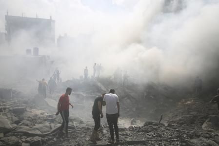 Palestinians look for survivors after an Israeli airstrike in Rafah refugee camp, southern Gaza Strip, Thursday