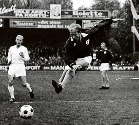 FILE - England's Bobby Charlton, plays for the Rest of Europe against Scandinavia, in a show soccer match to celebrate the 75th anniversary of the Danish Football Association, in Copenhagen, Denmark. Bobby Charlton, an English soccer icon who survived a plane crash that decimated a Manchester United team destined for greatness to become the heartbeat of his country's 1966 World Cup-winning team, has died. He was 86. A statement from Charlton's family, released by United, said he died Saturday Oct. 21, 2023 surrounded by his family. (AP Photo/File)