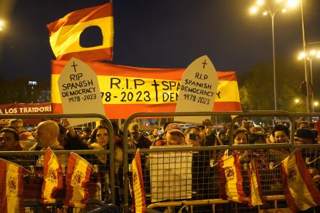 People protest behind security barriers during the investiture debate a day before the Socialist leader seeks the endorsement of the chamber to form a new government at the nearby Spanish Parliament in Madrid Spain, Wednesday, Nov. 15, 2023. Demonstrators are protesting Spain's Socialist's deal to grant amnesty to Catalan separatists in exchange for support of new government. (AP Photo/Andrea Comas)