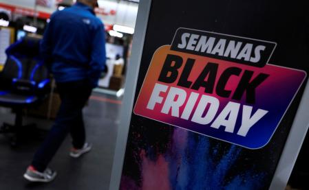 People walk past a sign advertising pre-Black Friday offers, in Barakaldo, Spain, November 15, 2023. REUTERS/Vincent West