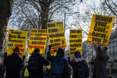 LONDON, ENGLAND - DECEMBER 6: Anti-vaccine protesters hold placards as they demonstrate outside the Covid Inquiry on the day that Boris Johnson, Britain's former Prime Minister, is due to testify, on December 6, 2023 in London, England. Britain's former Prime Minister will be questioned during phase 2 of the Covid-19 Inquiry over government decision-making during the pandemic. (Photo by Carl Court/Getty Images)