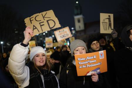 BERLIN, GERMANY - JANUARY 17: (EDITORS NOTE: Image contains profanity.) People gather in the city center to protest against the far-right Alternative for Germany (AfD) political party on January 17, 2024 in Berlin, Germany. Several thousand people gathered today in Berlin in one of a number of similar protests this week across Germany. The AfD is under heavy public scrutiny following the recent revelation that Roland Hartwig, a former AfD Bundestag parliamentarian and until recently an advisor to AfD co-leader Alice Weidel, had taken part in a meeting last year with neo-Nazis, including Austrian far-right extremist Martin Sellner, at a villa near Potsdam. According to the investigative group Correctiv participants at the meeting discussed how to possibly introduce legislative measures to enable the mass expulsion of immigrants from Germany, as well as German citizens with immigrant roots and German citizens who have helped refugees. News of the meeting has prompted renewed calls for banning the AfD.   (Photo by Sean Gallup/Getty Images)