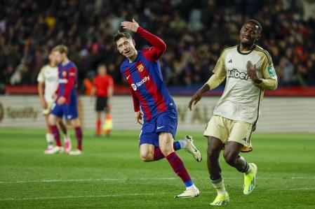Barcelona's Robert Lewandowski, left, celebrates scoring his side's 2nd goal during the Spanish La Liga soccer match between Barcelona and Granada at the Olimpic Lluis Companys stadium in Barcelona, Spain, Sunday, Feb. 11, 2024. (AP Photo/Joan Monfort)