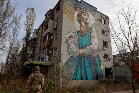 FILE PHOTO: A Ukrainian serviceman walks next to a residential building heavily damaged by permanent Russian military strikes in the front line town of Avdiivka, amid Russia's attack on Ukraine, in Donetsk region, Ukraine November 8, 2023. Radio Free Europe/Radio Liberty/Serhii Nuzhnenko via REUTERS/File Photo