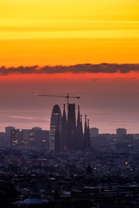 Amanecer de la Torre Glòries y la Sagrada Familia en Barcelona.