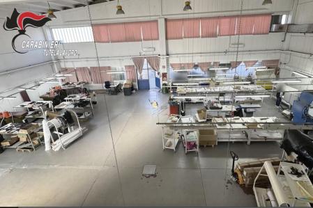 In this frame grab taken from a footage released, Friday, April 5, 2024, by the Italian Carabinieri, paramilitary police press office, showing a workshop where leathergoods were being made in northern Italy. Underpaid and exploited Chinese workers working for an unauthorized subcontractor made handbags and accessories for the Giorgio Armani fashion house that was contracted through a subsidiary that did not properly monitor conditions, Italian police said in a statement Friday. The Giorgio Armani fashion house denied abuses by GA Operations, which produces Giorgio Armani fashion collections. (Italian Carabinieri Via AP)