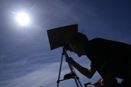Mike Porter usa un telescopio para observar el sol mientras se prepara para observar un eclipse solar total el lunes 8 de abril de 2024 en Carbondale, Illinois