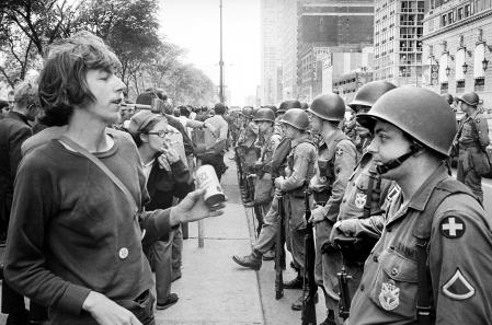 Group of People standing in front of row of National Guard soldiers, across from Hilton Hotel at Grant Park during Democratic National Convention, Chicago, Illinois, USA, Warren K. Leffler, August 26, 1968. (Photo by: Universal History Archive/Universal Images Group via Getty Images)