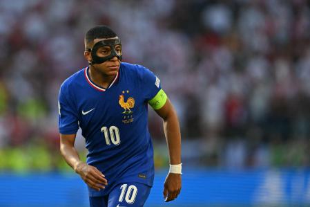 TOPSHOT - France's forward #10 Kylian Mbappe, wearing a protective mask, looks on during the UEFA Euro 2024 Group D football match between France and Poland at the BVB Stadion in Dortmund on June 25, 2024. (Photo by OZAN KOSE / AFP)