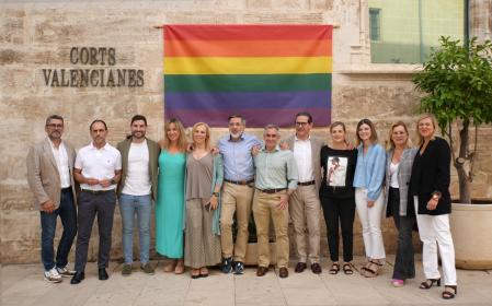 Los representantes del PP el día del Orgullo Gay, con la bandera en la fachada de Les Corts.