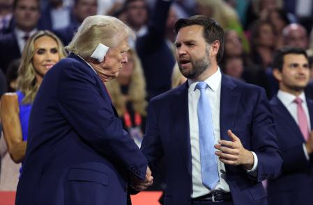 Republican presidential nominee and former U.S. President Donald Trump and Republican vice presidential nominee J.D. Vance interact during Day 1 of the Republican National Convention (RNC), at the Fiserv Forum in Milwaukee, Wisconsin, U.S., July 15, 2024. REUTERS/Andrew Kelly
