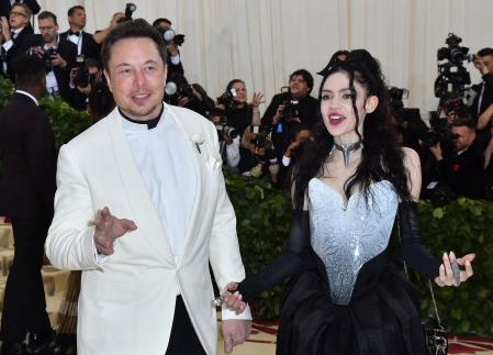 (FILES) In this file photo taken on May 07, 2018, Elon Musk and Grimes arrive for the 2018 Met Gala at the Metropolitan Museum of Art in New York. - Billionaire entrepreneur Elon Musk and the musician Grimes have had a second child, a girl they named Exa Dark Sideræl Musk -- although the parents will mostly call her Y. The 33-year-old Grimes revealed the existence of the child, who was born in December, in an interview published on March 10, 2022, by Vanity Fair. (Photo by ANGELA WEISS / AFP)