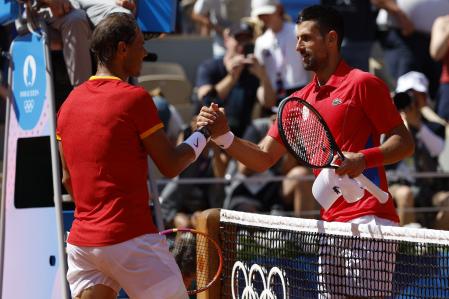 Paris (France), 29/07/2024.- Rafael Nadal of Spain congratulates Novak Djokovic of Serbia on his win in their Men's Singles second round match at the Tennis competitions in the Paris 2024 Olympic Games, at the Roland Garros in Paris, France, 29 July 2024. (Tenis, Francia, España) EFE/EPA/FRANCK ROBICHON