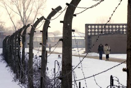 ORANIENBURG, Germany:  People walk in the Sachsenhausen concentration camp in Oranienburg just north of Berlin 27 January 2006 on the first international day of commemoration for the victims of the Holocaust.  Sentence on the gate reads: 