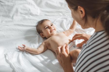 Mother and baby girl in bedroom.