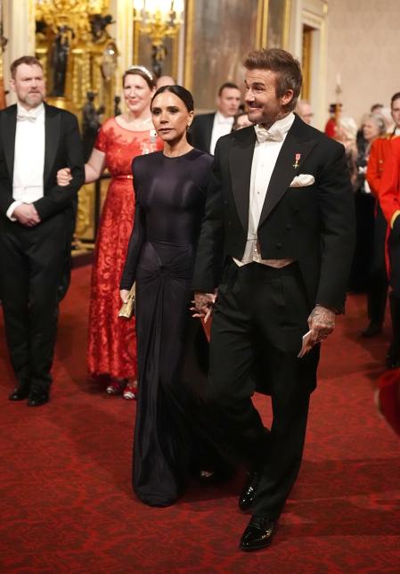 David and Victoria BeckhH make Heir way along the East Gallery to attend the state banquet for the Emir of Qatar Sheikh Tamim bin Hamad Al Thani at Buckingham Palace, London, during his state visit to the UK. Picture date: Tuesday December 3, 2024. *** Local Caption *** .