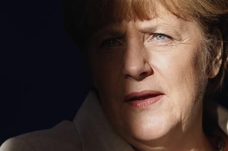 File - German Chancellor Angela Merkel is pictured with light and shadow at the Meseberg palace near Berlin, Germany, Thursday, Jan. 23, 2014. (AP Photo/Michael Sohn, File)